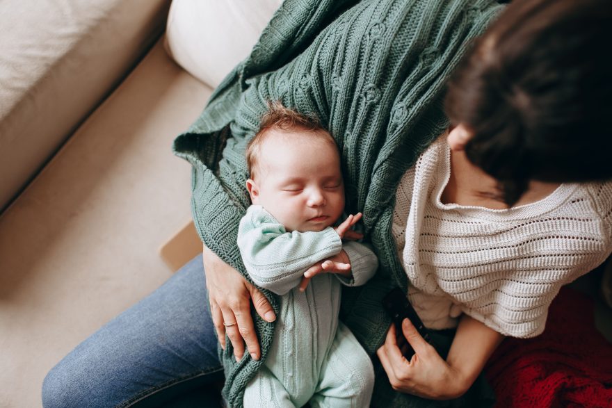 Mère tenant son nouveau-né endormi avec tendresse